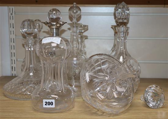 Eight glass decanters and claret jugs, some with silver wine labels